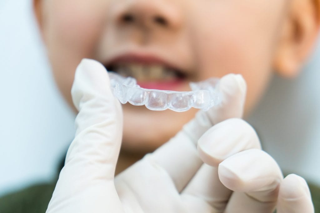 Closeup of hand holding retainer